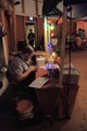 The bracelet tying hot dog salesman